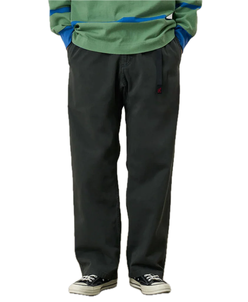 Person wearing a green jacket and black pants 