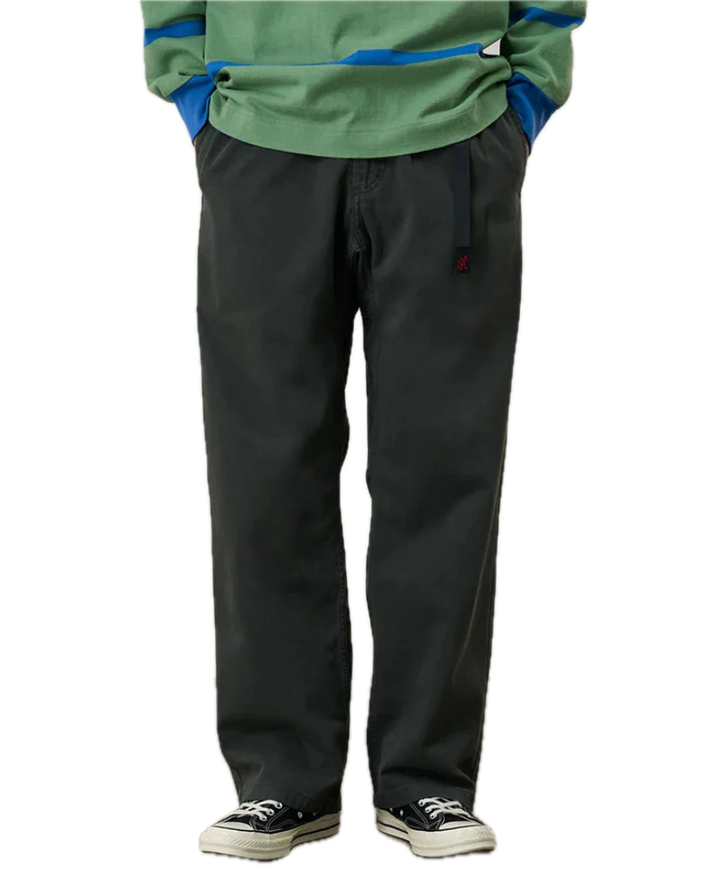 Person wearing a green jacket and black pants 