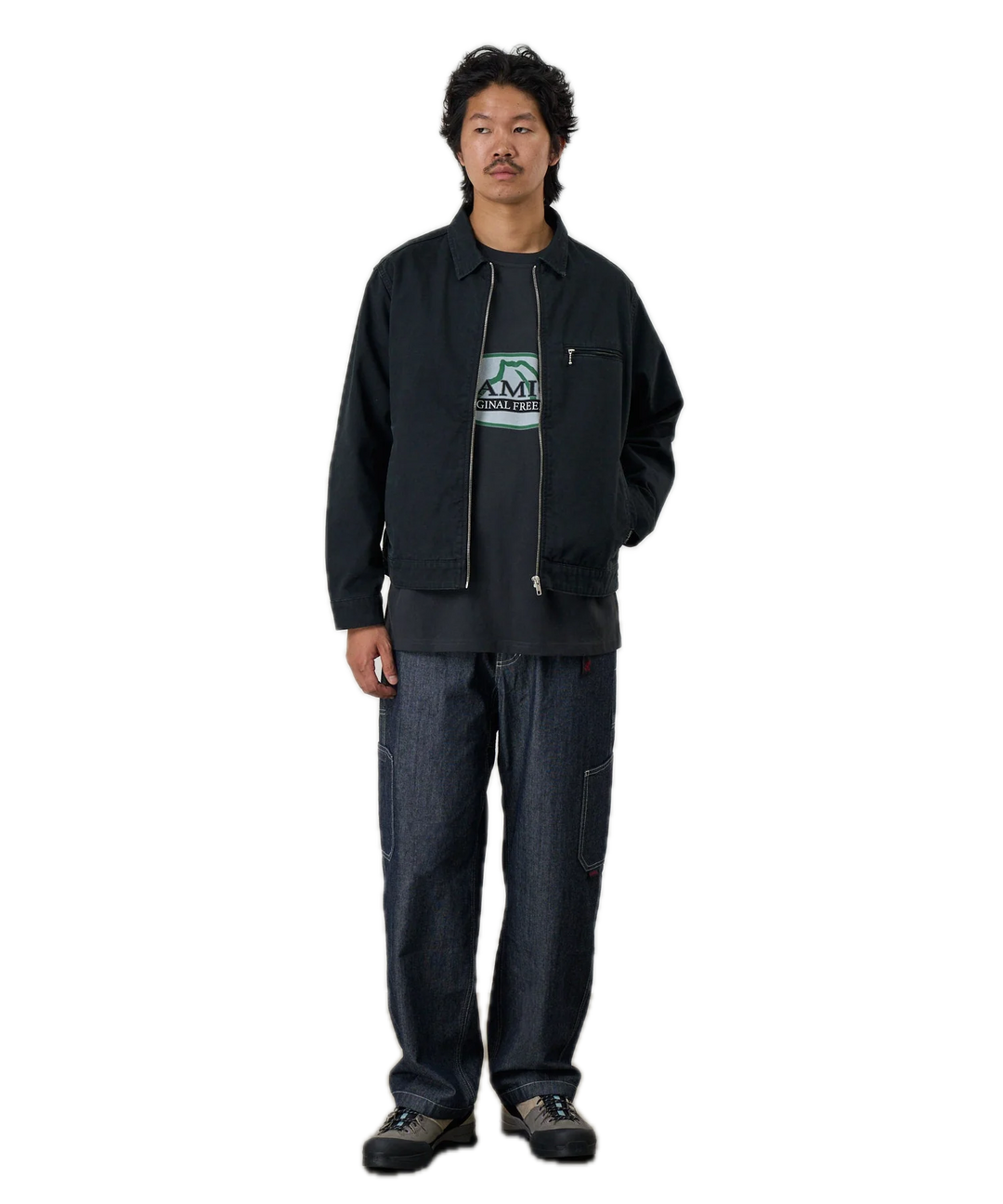 Person wearing a black jacket with a logo 