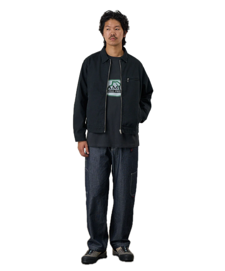 Person wearing a black jacket with a logo 