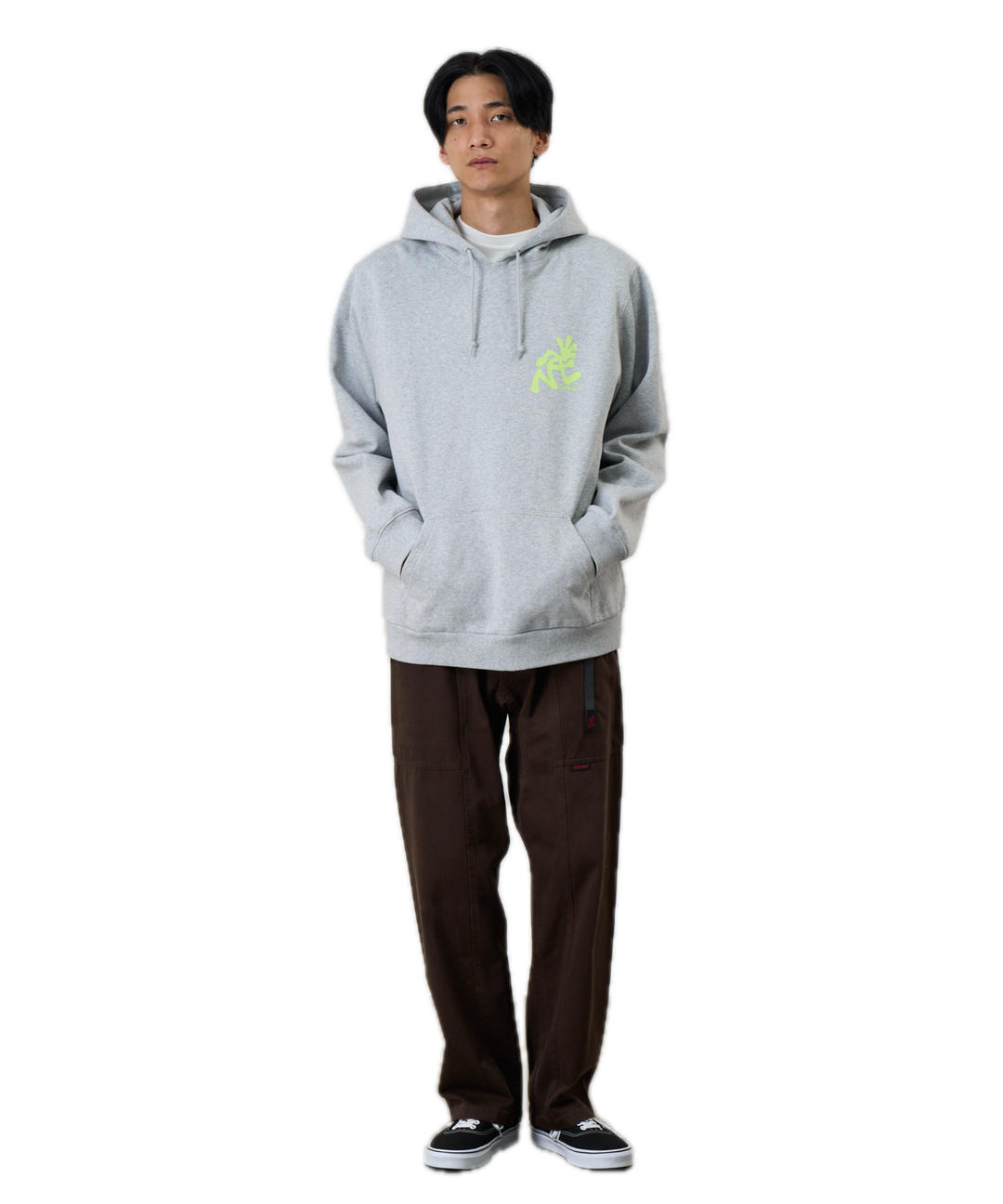 Person wearing a gray hoodie with a green logo 
