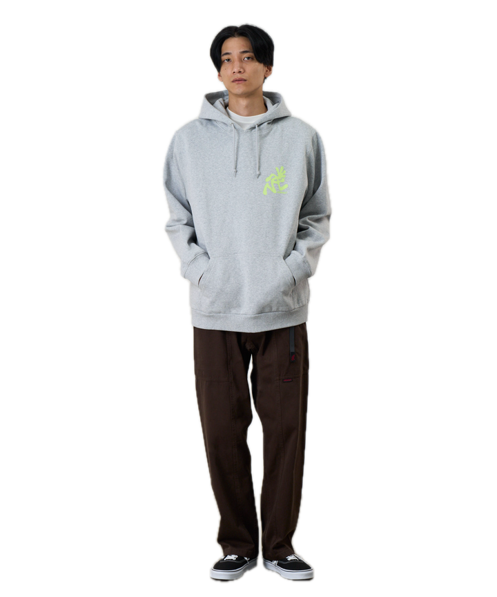 Person wearing a gray hoodie with a green logo 