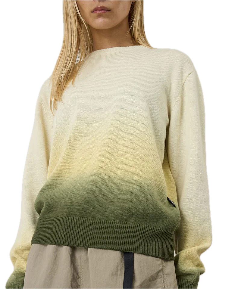 Person wearing a gradient sweater with beige, green, and brown colors 