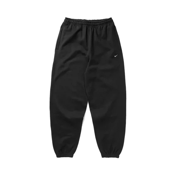 Black jogger sweatpants with an elastic waistband and cuffs, featuring a small white Nike swoosh on the left thigh, shown against a plain white background.