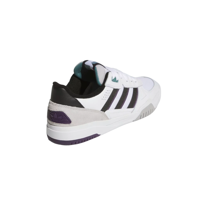 White Adidas sneaker with black stripes on a light gray background