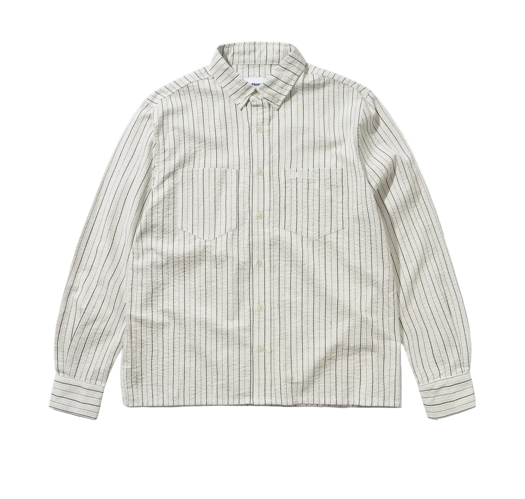 A long-sleeve button-up shirt with vertical pinstripes in beige and white, featuring two chest pockets and a classic collar, laid flat against a white background.