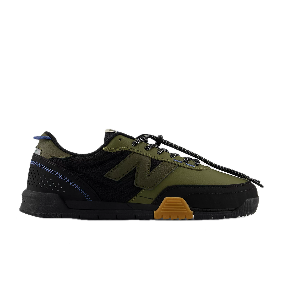 Green and black sneaker with a brown sole 