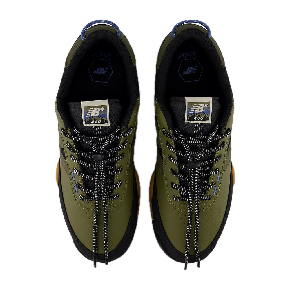 Pair of green sneakers with black laces 