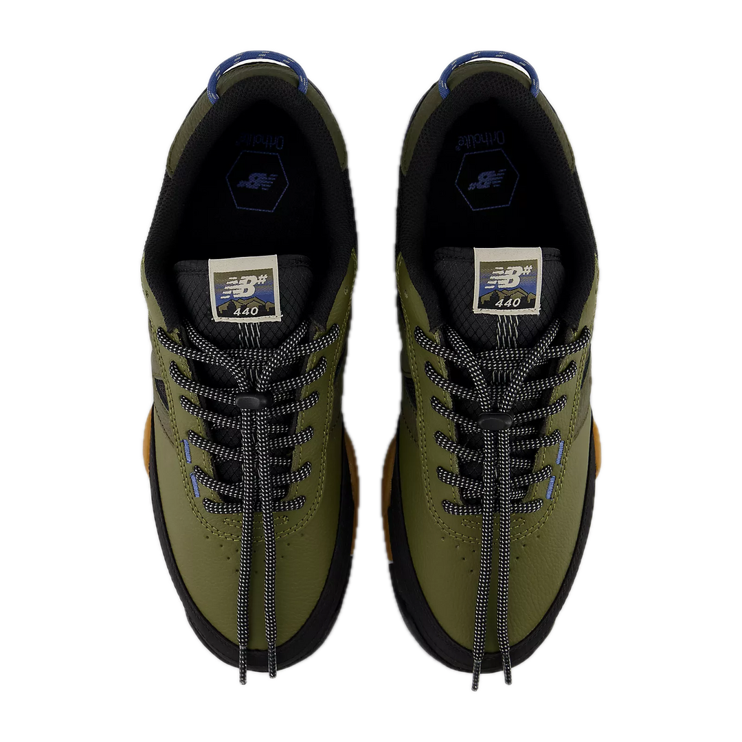 Pair of green sneakers with black laces 