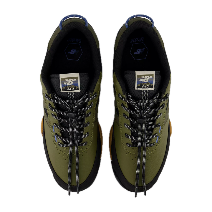 Pair of green sneakers with black laces 